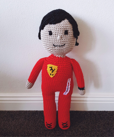 Crocheted doll of Formula One driver Carlos Sainz.